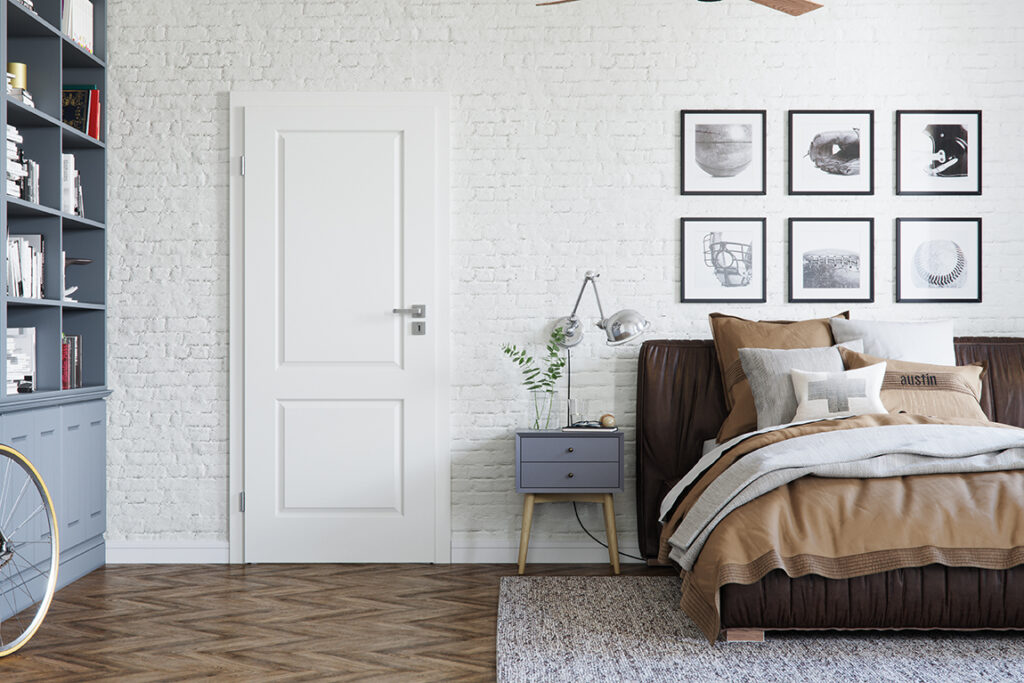 Elegant white interior door with a luxury designer handle in a modern bedroom, featuring a stylish blend of contemporary decor, textured brick walls, and cozy furnishings, enhancing the room's sophisticated aesthetic.