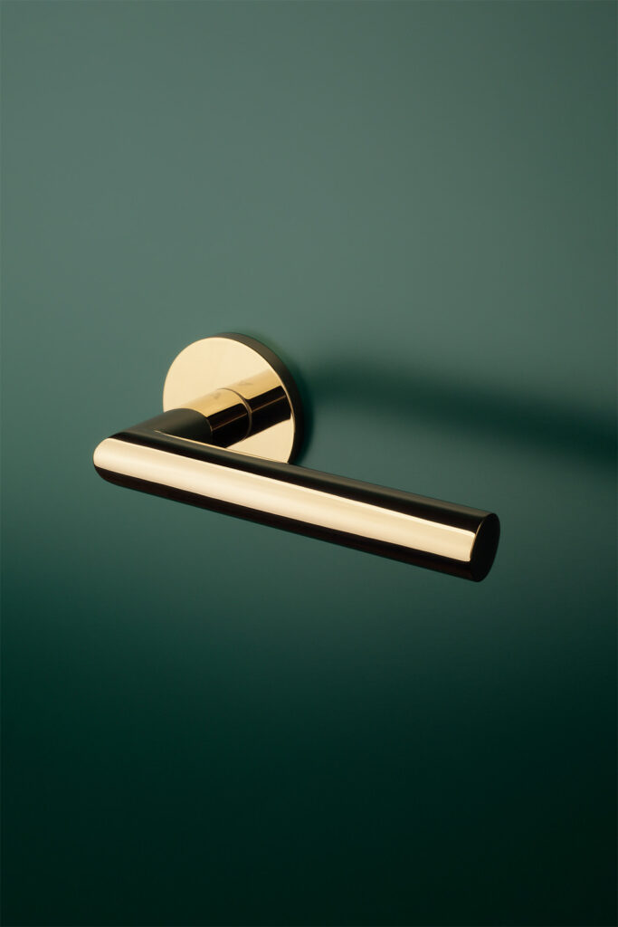 Aprile luxury interior door handle in a polished gold finish with a sleek, cylindrical design and round base, perfect for adding a touch of elegance and modern sophistication to any home interior.